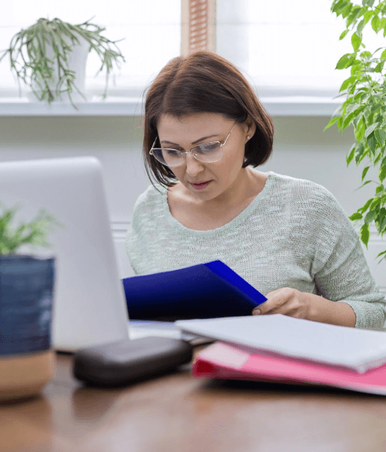 A curriculum team compares translated units on a laptop as Ebook Translation Services preserve academic learning outcomes.