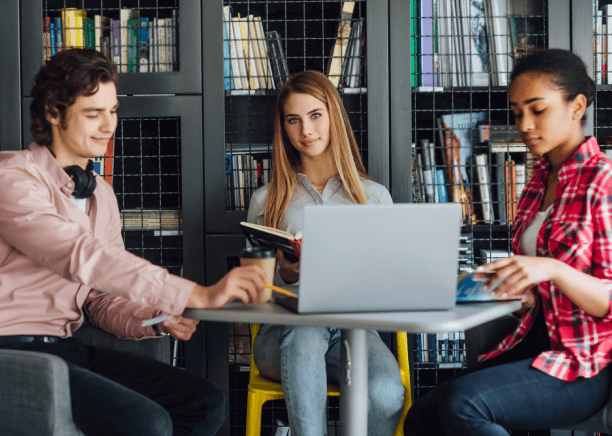 Students using a laptop in a library for academic translation services in Houston for students and institutions.