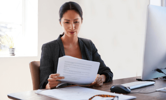 A legal reviewer marks clause changes while Contract Translation Services prepare a clear, accurate agreement draft.