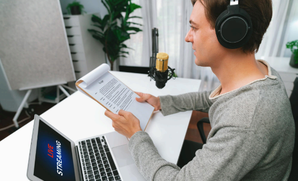 A specialist transcribes an interview recording on a laptop, using Calgary Translation Services for audio projects.