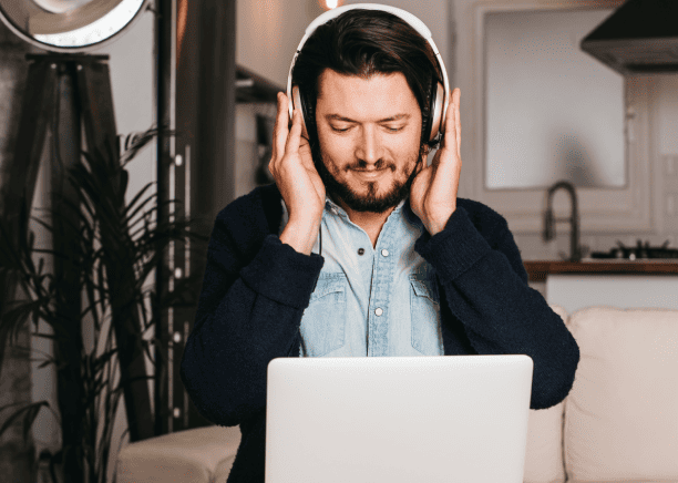 A visually impaired individual engaging with content through custom-tailored audio description services. A visually impaired individual engaging with content through custom-tailored audio description services.