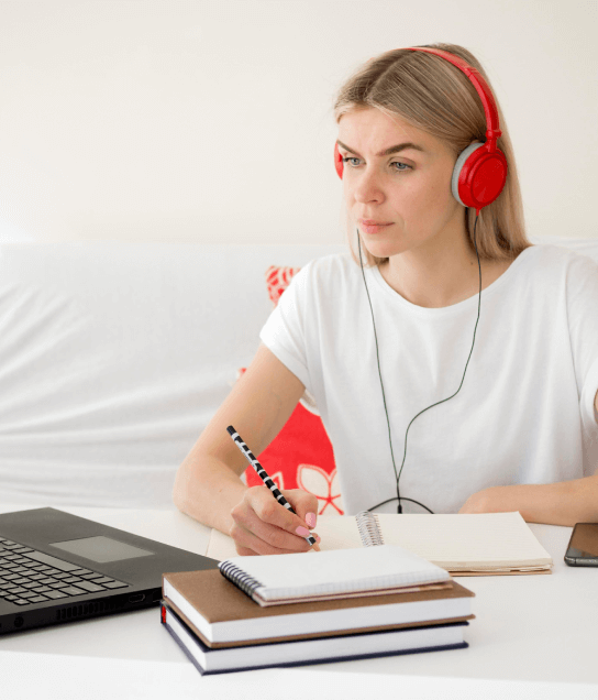 Women working on a laptop, demonstrating seamless transcription and translation services of audio files into English.