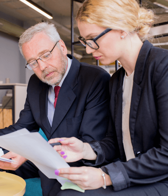 Professional discussing legal documents, highlight the importance of accurate bank statement translation services by experts.