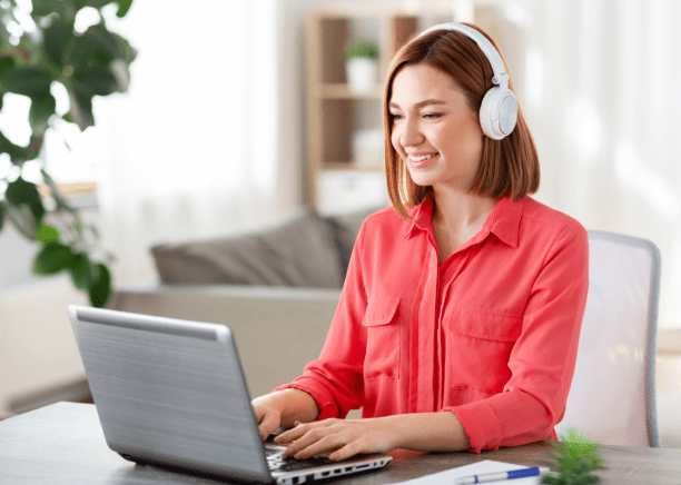 Young woman using laptop & modern microphone to record voice-over, highlighting benefits of voice-over translation services. Young woman using laptop & modern microphone to record voice-over, highlighting benefits of voice-over translation services.