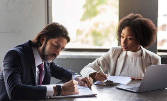 A manager compares bilingual contract pages during vendor onboarding, using Agreement Translation Services for business use.