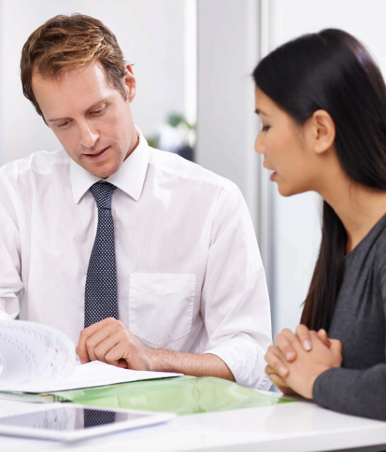 A manager reviews a bilingual contract as Minneapolis Translation Services completes business document translation.