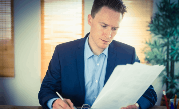 A PR coordinator compares a translated press release to the original as Salt Lake City Translation Services guides business.
