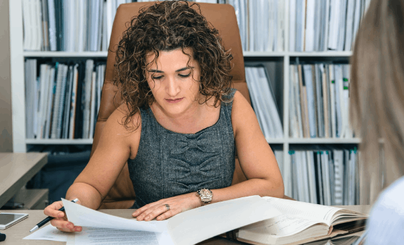 A client checks an application form while Asylum Translation Services deliver certified translations with clear formatting.