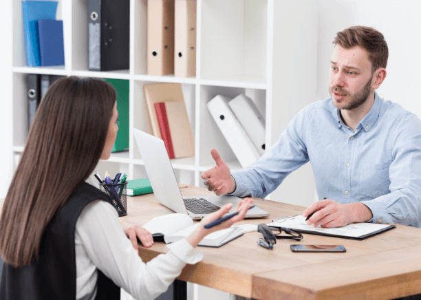 Two Translator collaborating in an office representing bank statement translation services for accuracy and reliability.