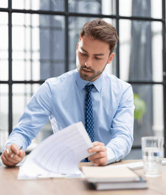 Professional reviewing documents to deliver certified Greek translation services on time for legal and medical content. Professional reviewing documents to deliver certified Greek translation services on time for legal and medical content.