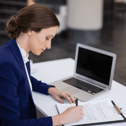 Translator working on certified documents using Las Vegas translation services for birth certificates and academic transcripts.