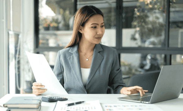 Certified expert using a laptop verifing the documents for certified translation services trusted in Charlotte