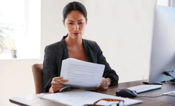 A reviewer checks consistent names across HR forms with Oklahoma City Translation Services for business client files.