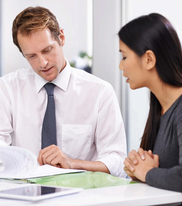 Two professionals review a contract before signing as Calgary Translation Services supplies certified translation.