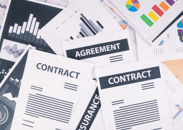 Business professional analyzing reports, showcasing meticulous contract translation services for various document types.