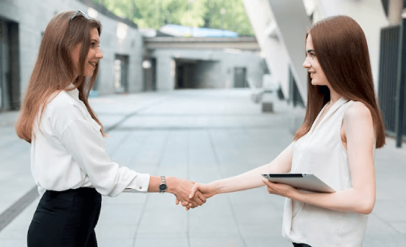 Client holds translated document, shakes hands with ATA-certified translator, highlighting accuracy in Cape Coral.