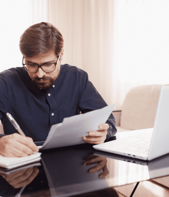 Skilled translator working with documents and a laptop, demonstrating diverse document translation for engineering needs. Skilled translator working with documents and a laptop, demonstrating diverse document translation for engineering needs.