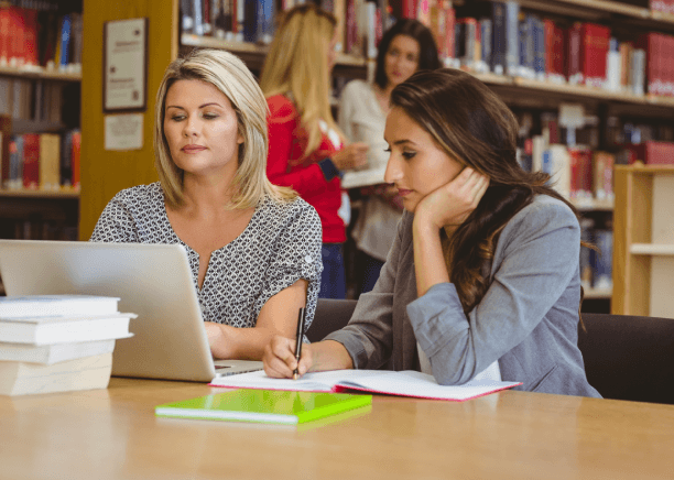 Two PhD linguists review a translated thesis together, delivering Thesis Translation Services with independent editing.