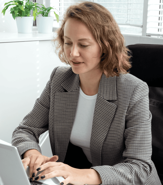 Expert using a laptop in a library, highlighting educational document translation service for accessible in Charlotte.