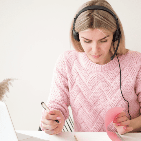 A translator works on a laptop, showcasing professional and fast audio transcription services for businesses, and media.