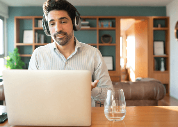 Young man working on a laptop, representing advanced features for audio and video translation solutions.