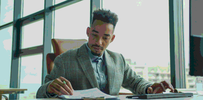 An analyst checks translated tables as Enterprise Translation Services prepares a financial report with verified figures.