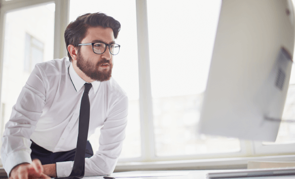 A focused translator reviewing a document, highlighting the process of delivering highly confidential translation services.