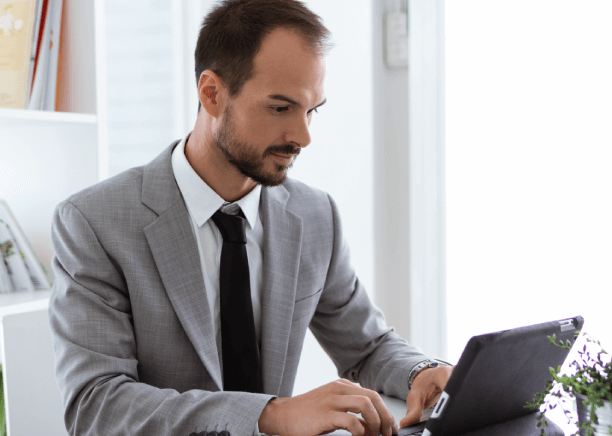 Young professional working on a laptop in a modern office, highlighting dependable features for banking translation services.
