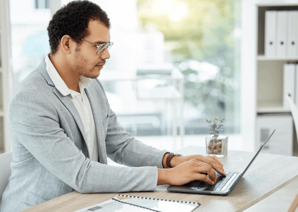 A translator checks an immigration form for USCIS as Asylum Translation Services match names and dates consistently.