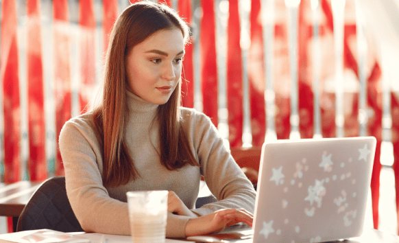 A woman working on her laptop, representing professional translation services in Milwaukee for industries.