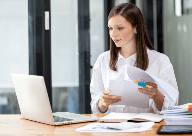 A QA lead checks an ISO checklist beside translated manuals, using Heavy Equipment Translation Services for ISO compliance.