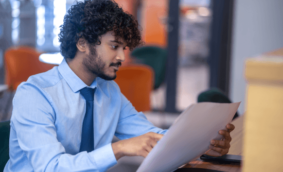 A customer reviews an ISO checklist beside a white paper draft, using White Papers Translation Services for certification.