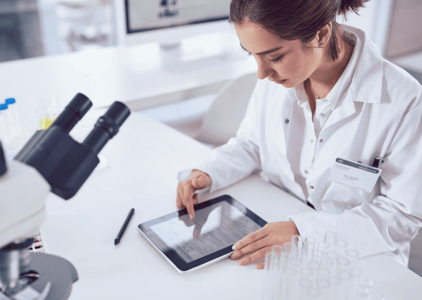 A scientist reviews documenting research data for the accuracy and reliability of life science research translations.