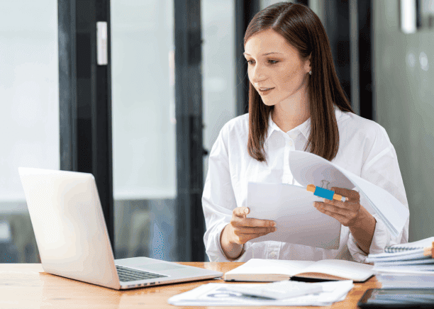 Woman using a laptop for product, highlighting accurate translation services for life sciences regulatory compliance.