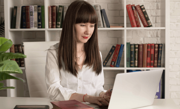 A translator compares three language EPUB proofs on a monitor as Ebook Translation Services keep tone and layout consistent.