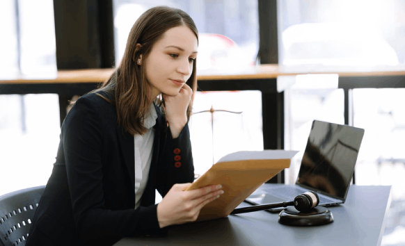 A reviewer highlights name spellings across multilingual documents as Asylum Translation Services verify dates and IDs.