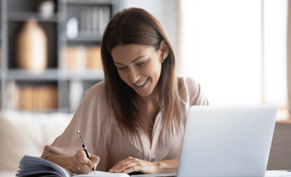 A translator compares an English and Spanish email draft using Newsletter Translation Services to keep multilingual tone.