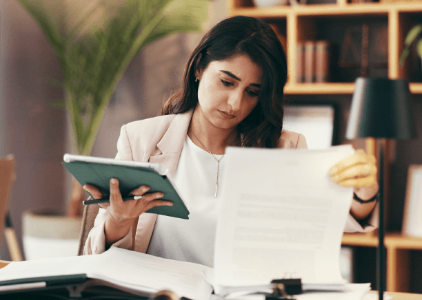 A native-language specialist translates an uploaded document at a desk, following Fredericksburg Translation Services steps.