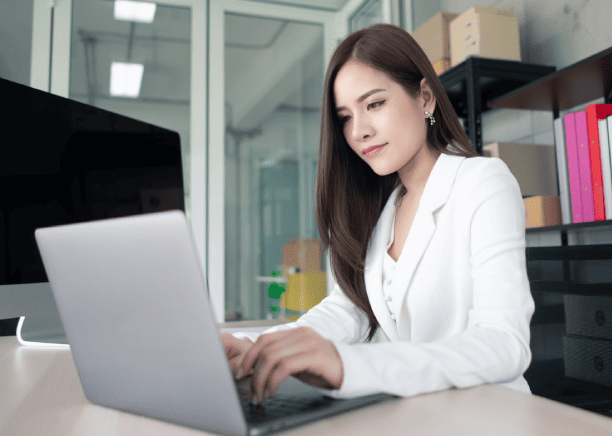 The translator works on a laptop, ensuring accurate and professional passport translation services.