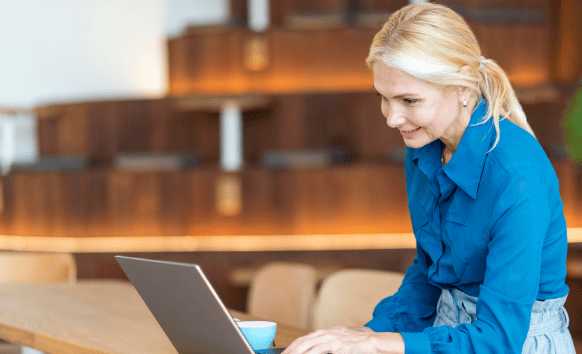 A senior woman working on a laptop, ensuring expert and reliable passport translation services.
