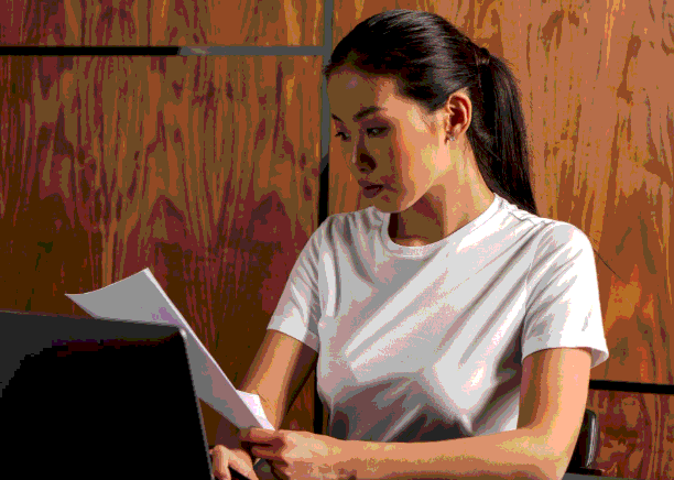 A QA lead checks a bilingual file in a secure portal as Enterprise Translation Services applies secure quality controls.