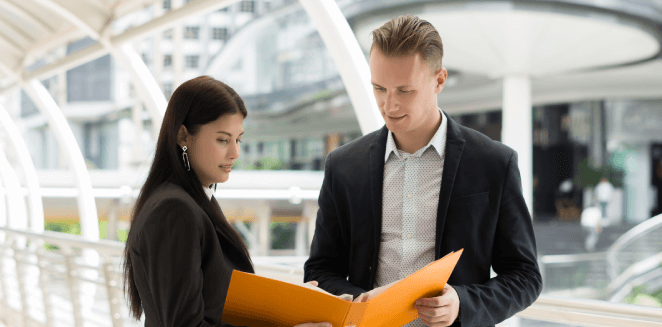 Real estate investor reviewing translated property documents, ensuring international transactions are seamless and secure. Real estate investor reviewing translated property documents, ensuring international transactions are seamless and secure.