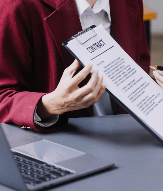 A tenant and agent sign a translated lease agreement, relying on New York Translation Services for affordable real estate.