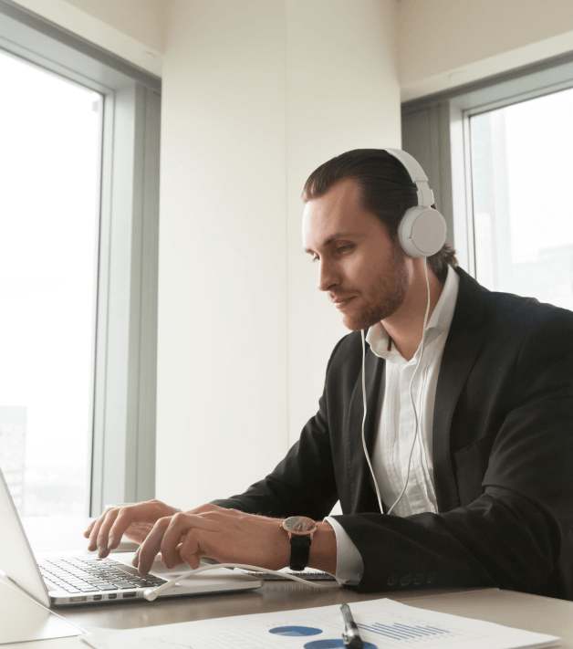 Translator working on a laptop, symbolizing tailored solutions with advanced support and scalable translation services.