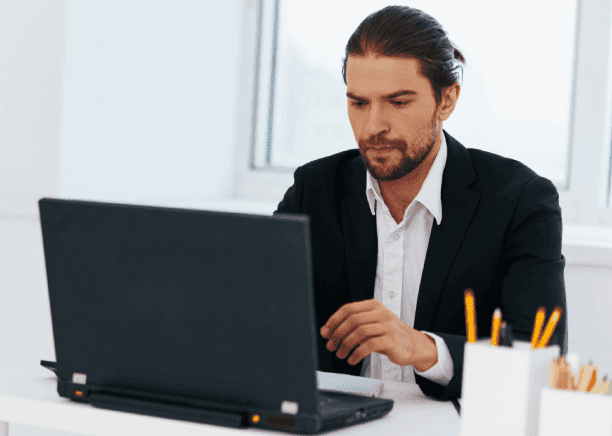 Native translator working on laptop, emphasizing trusted Spanish translation services for diverse Charlotte-based needs.