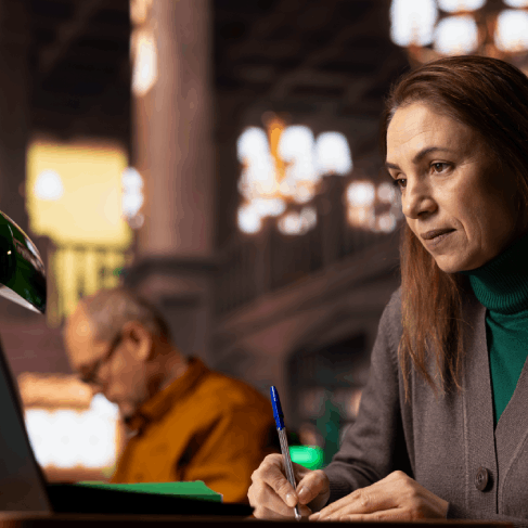 A translator edits a software user guide with tracked changes, using New York Translation Services for technical terms.