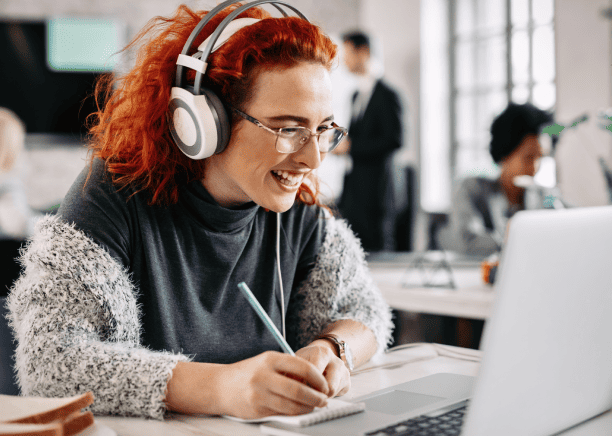 Expert working on a laptop, illustrating expert linguistic transcription and translation services of audio content.