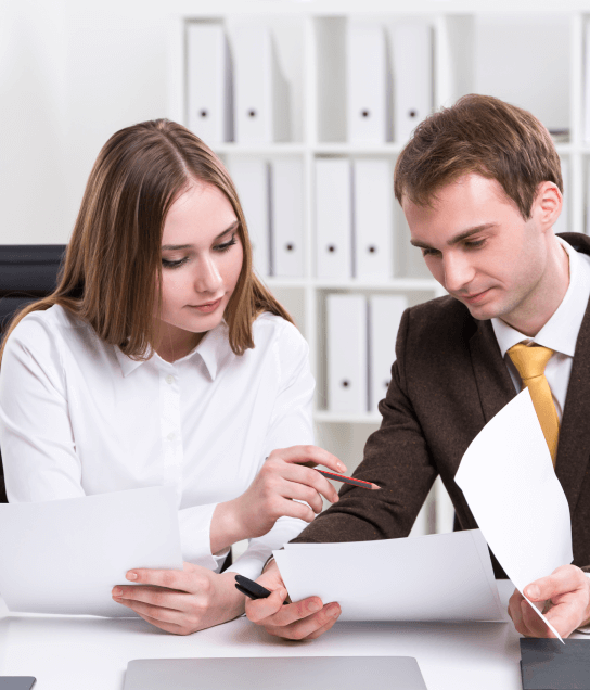 Two professionals reviewing documents, showcasing expert translation services for both personal and professional records. Two professionals reviewing documents, showcasing expert translation services for both personal and professional records.