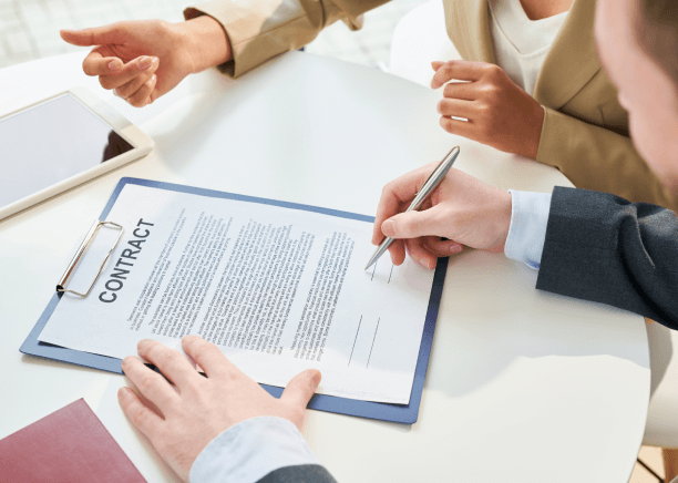 An expert translator signing contract, representing reliable translation services for legal agreements and personal documents. An expert translator signing contract, representing reliable translation services for legal agreements and personal documents.