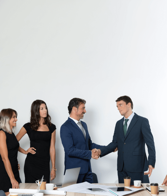 Two translators shake hands in Houston, representing the collaboration by Translation in Houston across multiple industries.